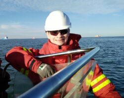 Smiling man on board a vessel at sea.