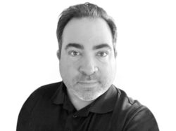Black and white head shot of man.
