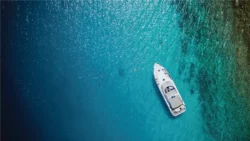 birds eye view of motorboat at anchor in tropical seas