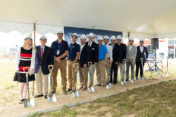 Line of people in hardhats with spades