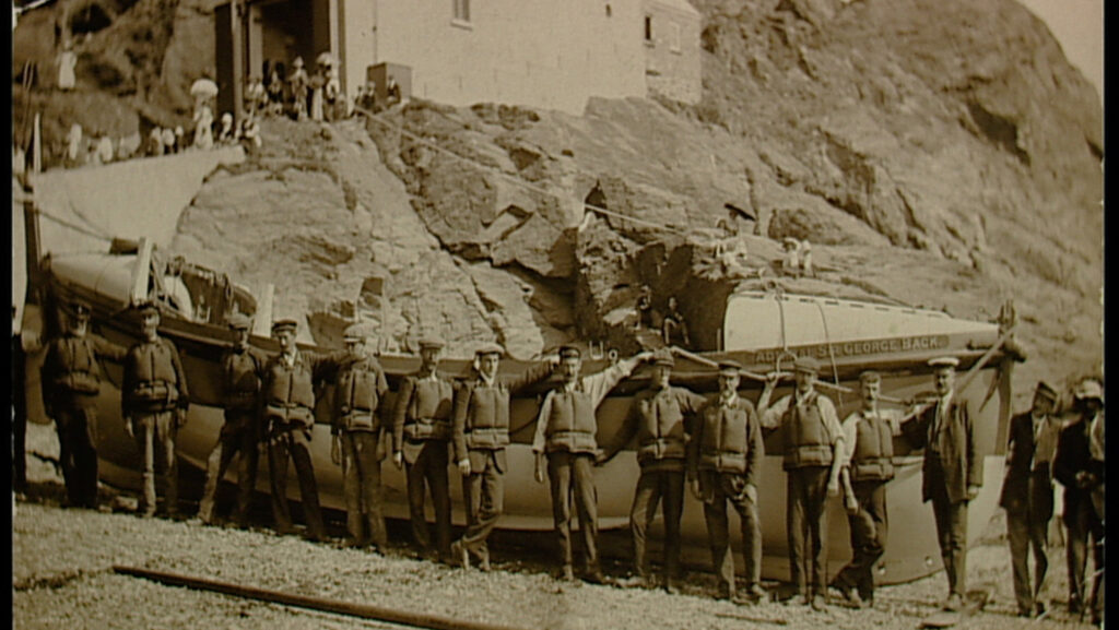 The Lizard lifeboat of 1907 the Admiral Sir George Back, and its crew of volunteers. The lifeboat went to the aid of the Suevic liner which ran aground on rocks. Black and white photo. Cadgwith.
