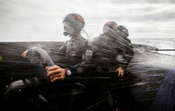 spray hitting sailors on very fast performance yacht