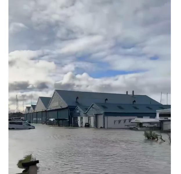 Hamble Point Marina road flooded with water pushing up against buildings