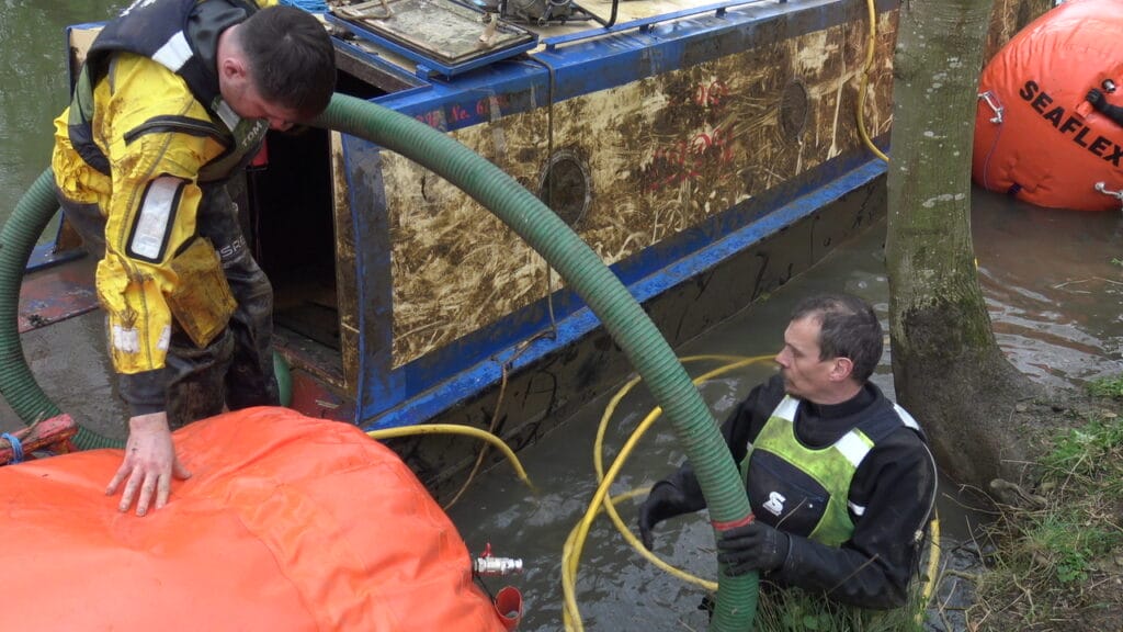 submerged boat being pumped out