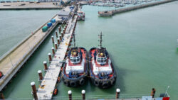 Two small workboat tugs alongside pontoon