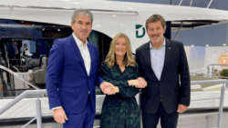 Three people shake hands on a deal which sees Le Boat invest into Groupe Beneteaus Delphia
